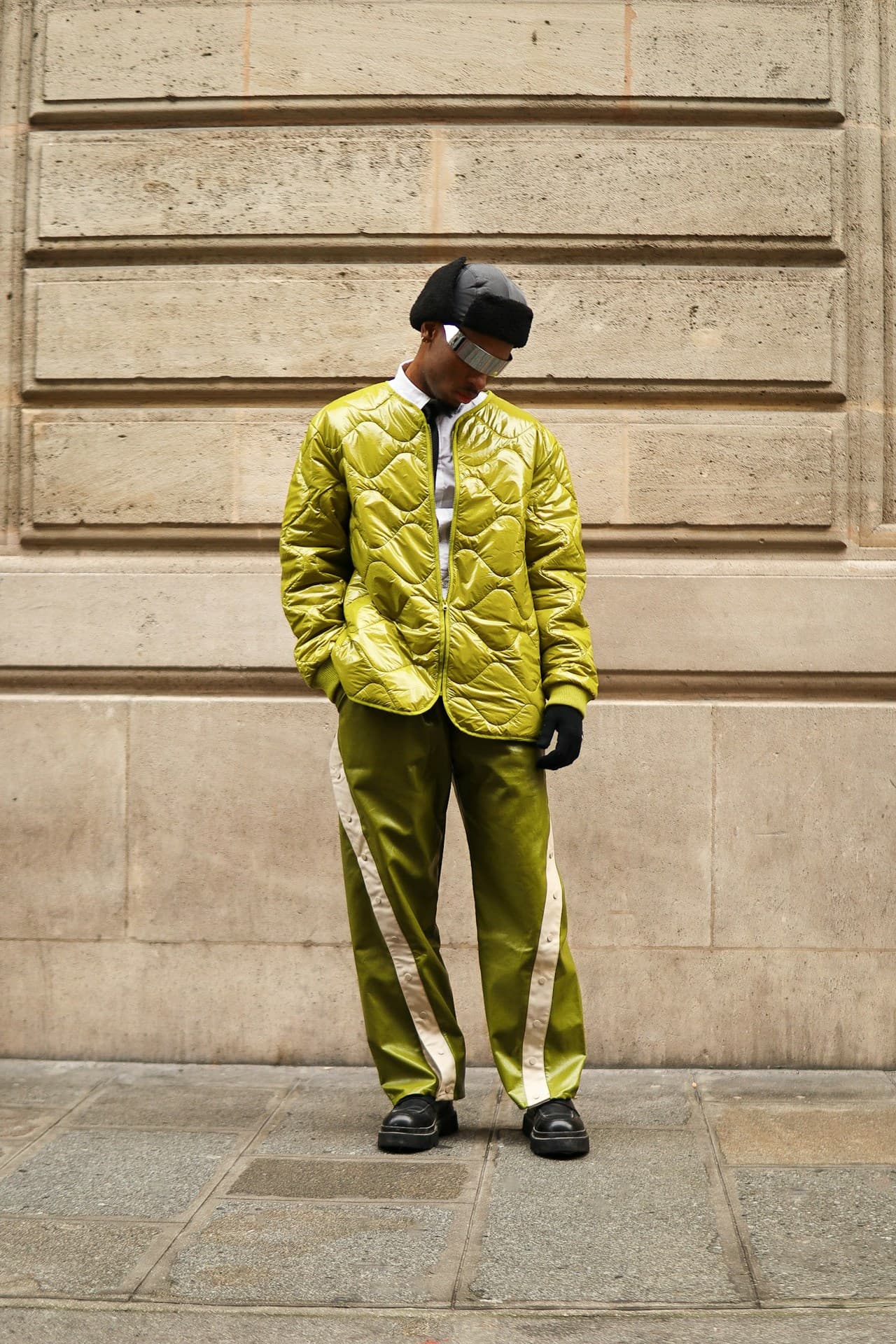A man in a yellow jacket and green pants