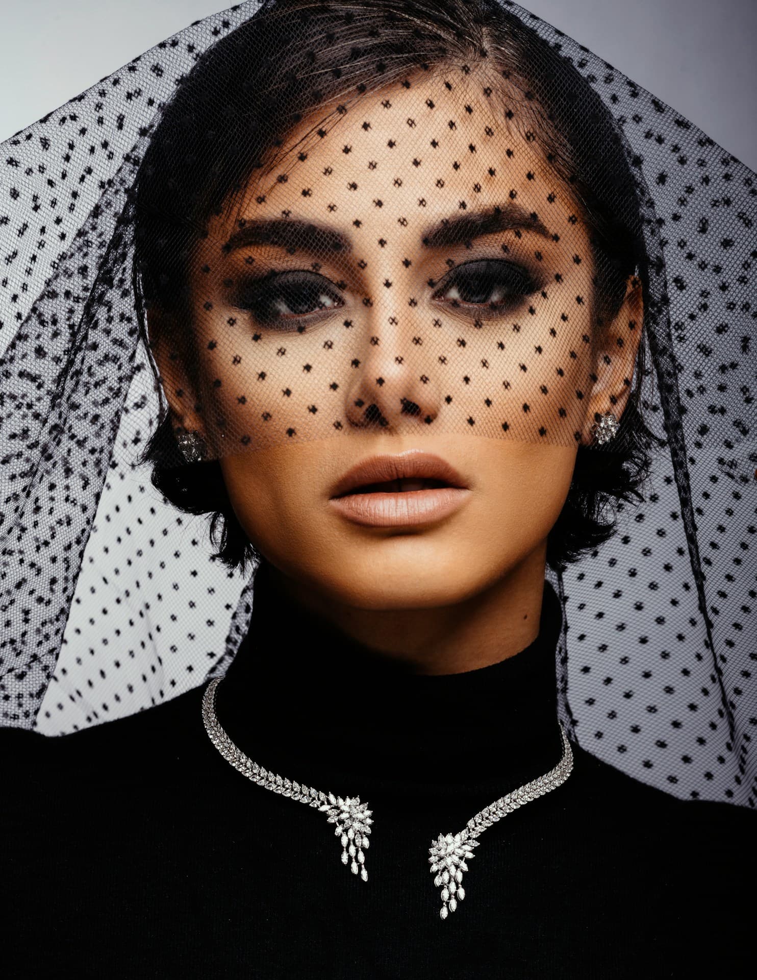 A woman with a veil over her head